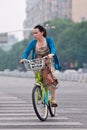 Elegant woman rides a public share bike, Beijing, China Royalty Free Stock Photo